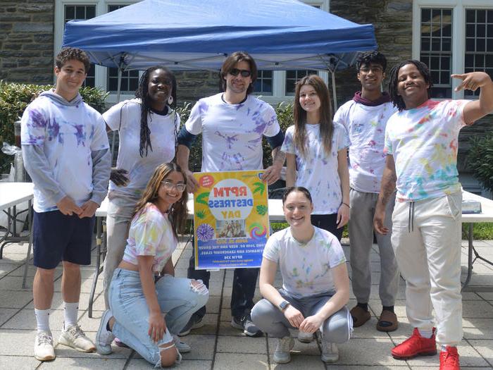 Students in front of a building with a sign